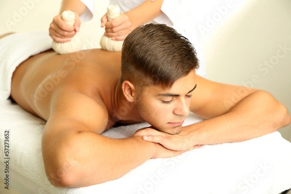 Fototapeta Young man having back massage close up