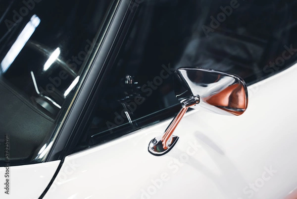 Fototapeta chrome rear mirror on white car with classic design