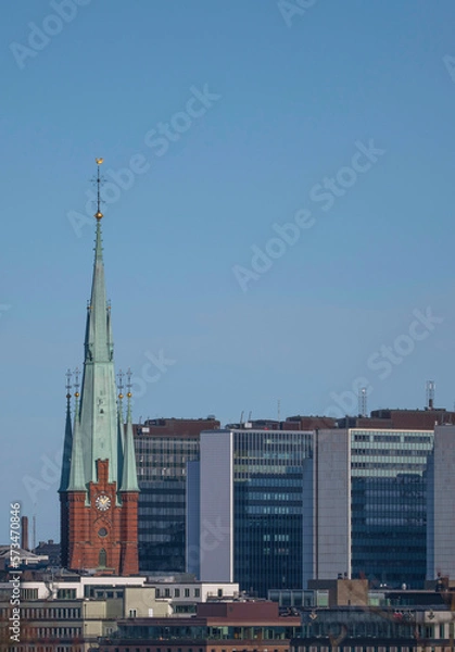 Fototapeta Church tower and skyscrapers in down town, a winter day in Stockholm