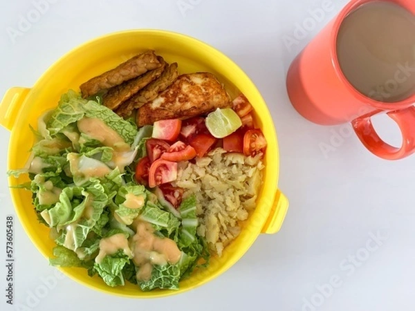 Fototapeta bowl of vegetable salad and hot coffee.