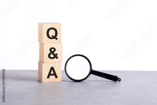 Fototapeta Q qand A - Question and Answer - text wooden cube blocks and magnifying glass on grey table