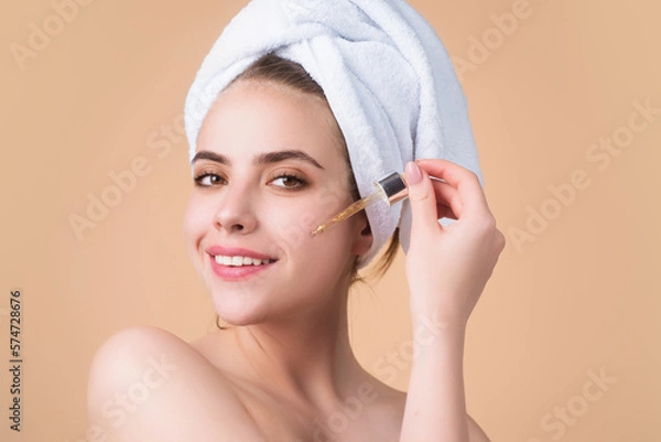 Fototapeta Woman shaping brown eyebrows. Woman eye with beautiful eyebrows. Shaped brows, long eyelashes. Paint eyebrows. Girl contouring eyebrows on isolated studio background.