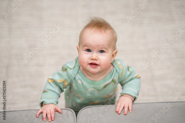 Fototapeta Portrait of charming Caucasian baby toddler with blue eyes in home in children room