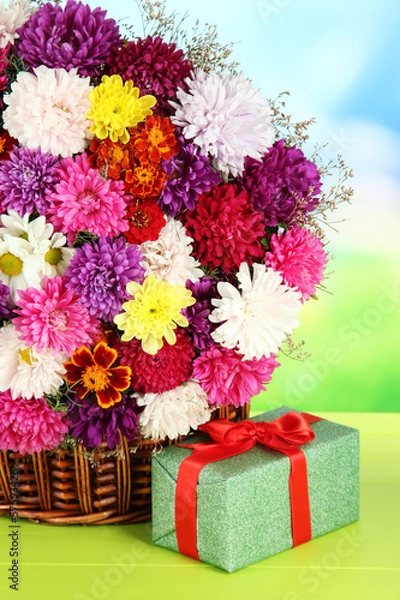 Fototapeta Beautiful bouquet of chrysanthemums in wicker basket