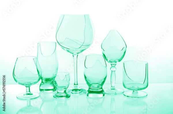 Fototapeta Broken empty wine glasses in blue on a white background.