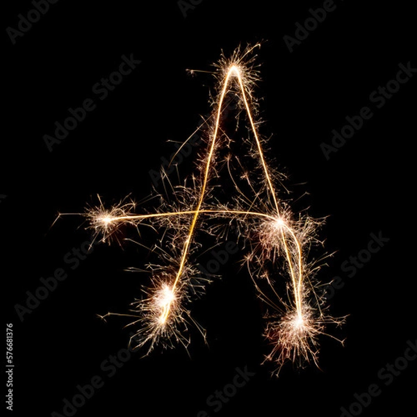 Fototapeta Sparkling burning creative letter A isolated on black background. Beautiful glowing golden overlay object for design holiday greeting card. Creative lettering A written with burning sparklers