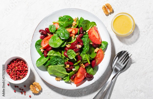 Fototapeta Red Bean Salad On Bright Background, Fresh Salad with Spinach, Cherry Tomatoes, Walnuts, Beans and Mustard Dressing