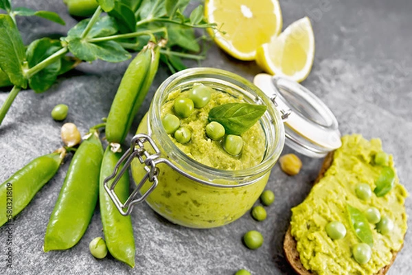 Obraz Hummus from green peas in glass jar on table