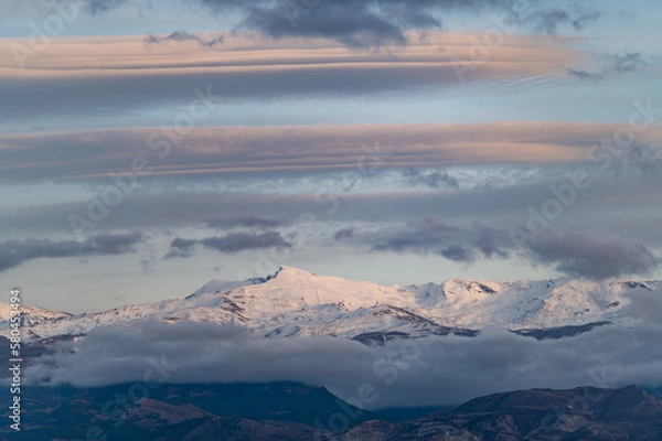 Fototapeta Panoramic view of large lenticular clouds over the snow-capped peaks of Sierra Nevada (Spain)