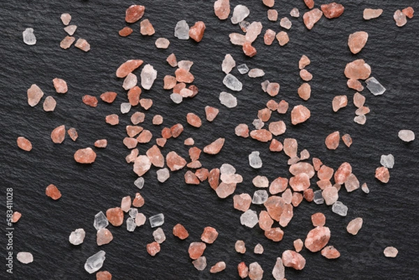 Fototapeta pink Himalayan salt used for spice and condiment in cooking on black slate background