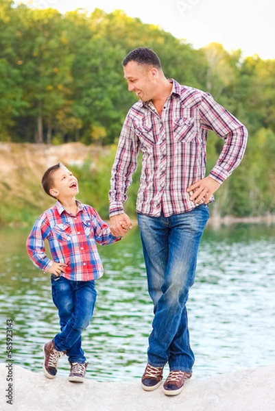 Fototapeta A Happy parent with child on nature in park travel