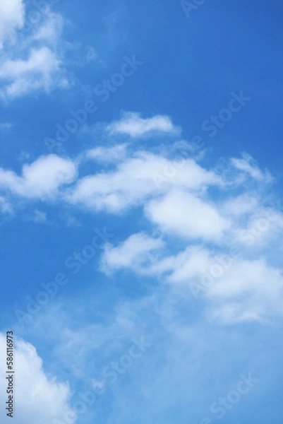 Obraz White Fluffy Clouds Flowing on Vibrant Blue Sky	