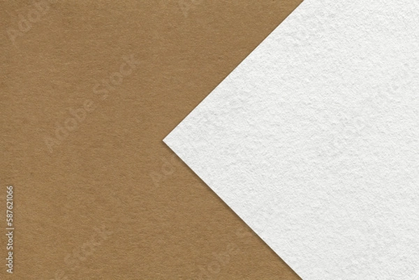 Fototapeta Texture of brown paper background, half two colors with white arrow, macro. Structure of dense craft beige cardboard.