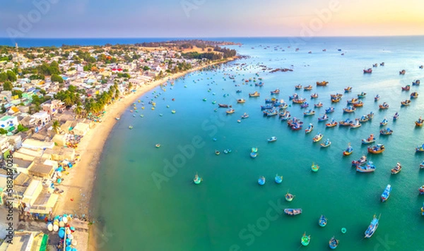 Fototapeta Aerial view of Mui Ne fishing village in the morning with hundreds of boats anchored to avoid storms, this is a beautiful bay in central Vietnam