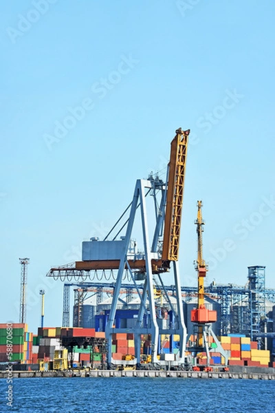 Fototapeta Port cargo crane and container over blue sky background