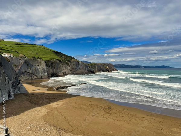 Fototapeta Nestled between beautiful cliffs, Itzurun beach, is very close to the town of Zumaia. This sandy area is part of one of the most spectacular stretches of the Basque coast, the Flysch route