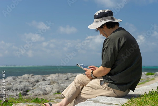 Fototapeta ワーケーション　旅行先で仕事をする男性