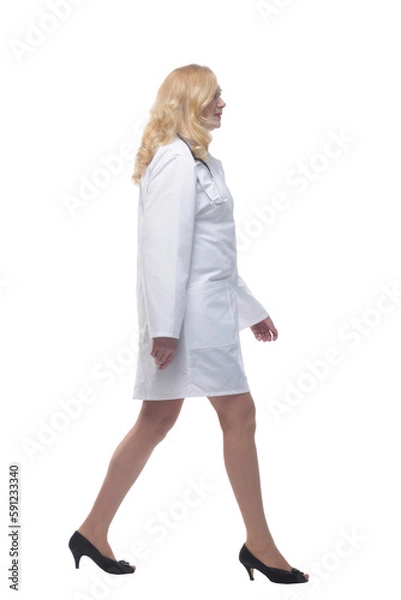 Fototapeta confident female doctor stepping forward . isolated on white background.