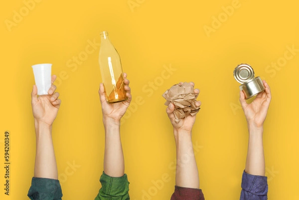 Fototapeta Hands keep garbage on a yellow background