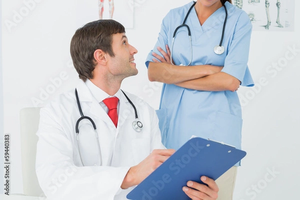 Fototapeta Doctors with reports in medical office