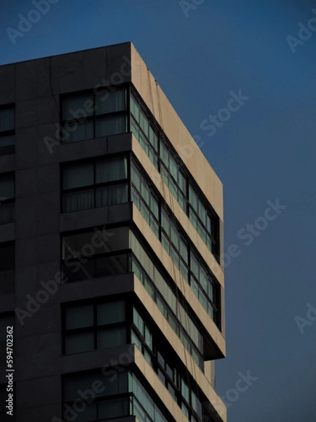 Fototapeta Tall building exterior at sunrise