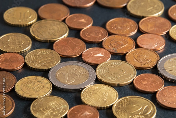 Fototapeta Euro coins close-up on black table. Euros and euro cents. Different European coins scattered on black background