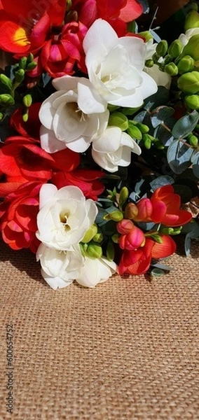 Fototapeta Beautiful bouquet of flowers. Delicate flowers close-up. Bouquet of white and orange flowers. Flowers for a gift. Floral background. Bouquet on the table.