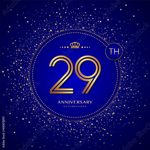 Fototapeta 29th anniversary logo with gold numbers and glitter isolated on a blue background