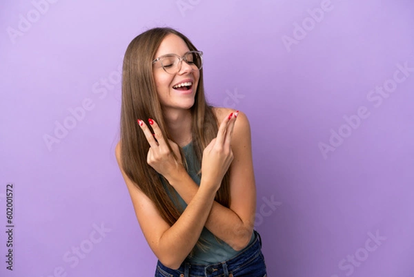 Fototapeta Young Lithuanian woman isolated on purple background smiling and showing victory sign