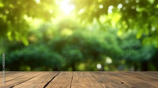 Fototapeta A wooden table with a green leafy background