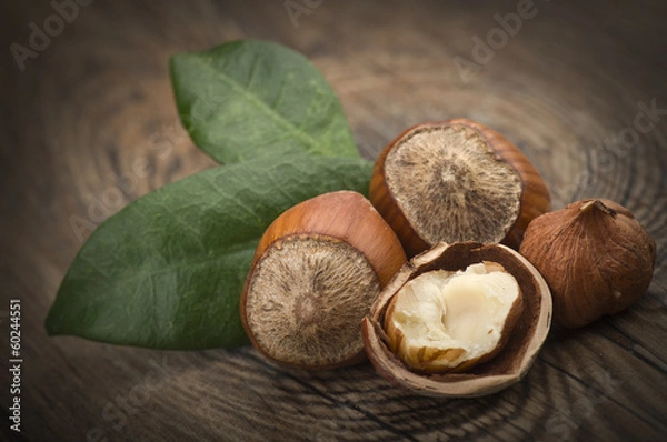 Fototapeta Hazelnuts group close up on the wooden table