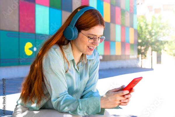 Fototapeta Redhead Girl. Street-Smart Telecommuter: Beautiful Redhead Thriving in Mobile Work and Digital Creativity