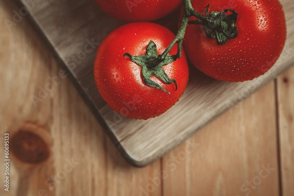 Fototapeta Tomatos on cutting board