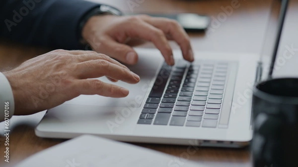 Fototapeta Man hands using touchpad on laptop typing documents at company office close up