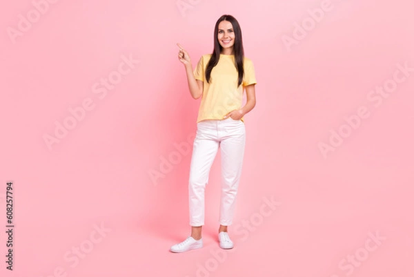 Fototapeta Full length photo of adorable pretty lady wear yellow t-shirt pointing finger empty space isolated pink color background