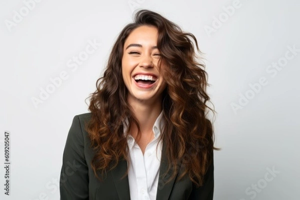 Fototapeta Portrait of a happy young business woman laughing isolated over white background