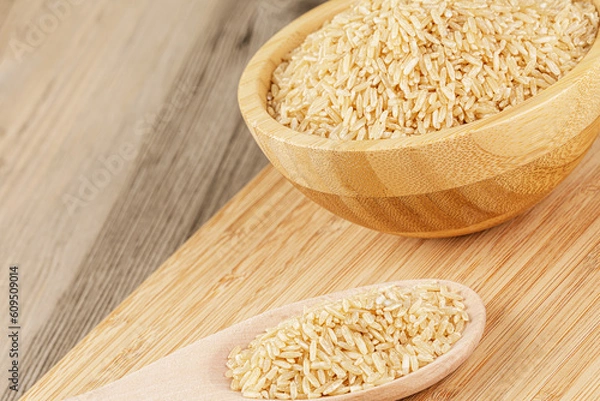 Fototapeta Close up of a wooden bowl of delicious uncooked Brown Rice