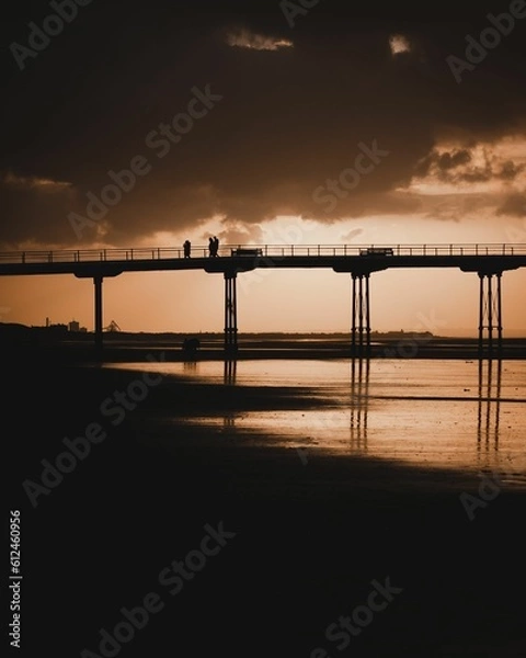 Fototapeta Silhouette shot of people at the pier at Saltburn beach in Saltburn-by-the-Sea, North Yorkshire