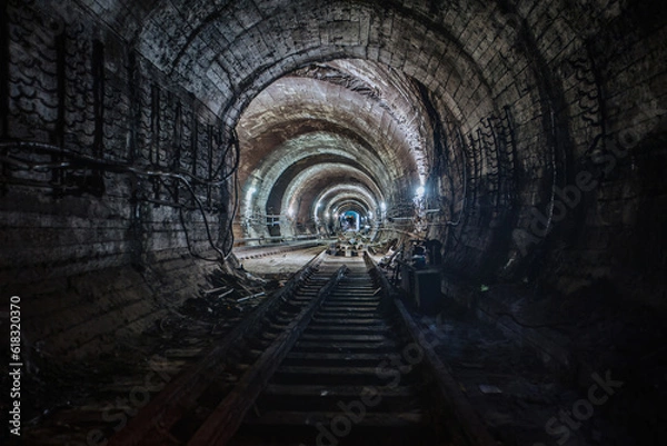 Fototapeta Round underground subway tunnel with tubing