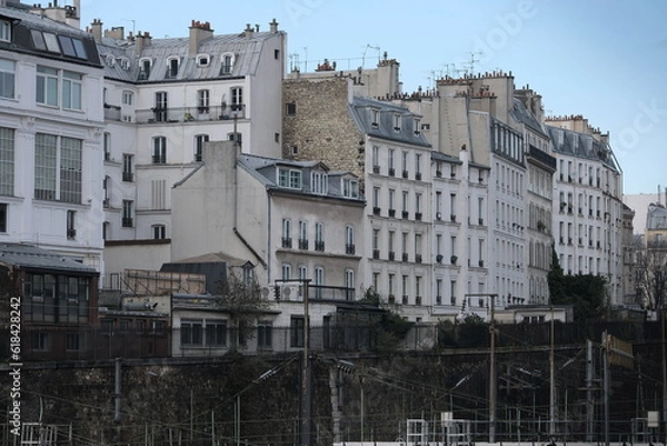 Fototapeta Paris building façades, characteristic roofs, and more.

It gathers many types of buildings, coming from various districts of the city; all passing through various settings of the day.