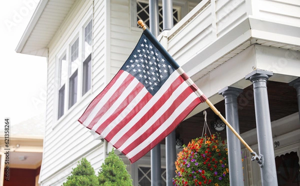 Fototapeta  US flag waving proudly, representing patriotism and the spirit of American holidays, evoking a sense of national pride and unity