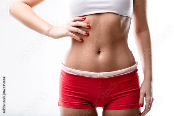 Fototapeta closeup of a good shaped woman's flat belly after or because of a good workout