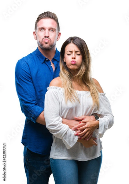 Obraz Young couple in love over isolated background puffing cheeks with funny face. Mouth inflated with air, crazy expression.