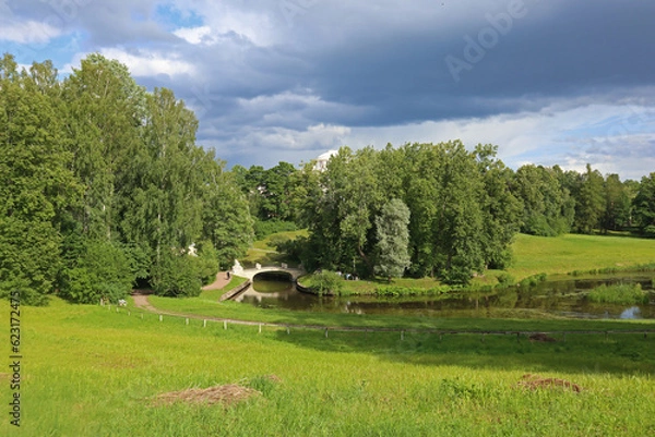 Fototapeta Beautiful park next to royal palace of the Russian Emperor Paul 1 and his family. Summer view of architecture of the Imperial residence and scenic landscape in Pavlovsk near St. Petersburg, Russia.