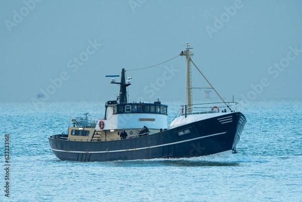 Fototapeta Motor Vessel 'Luna Azul' navigate near the harbour of Scheveningen, The Netheralnds