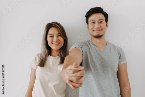 Obraz Happy smiling asian couple standing isolated on white background.