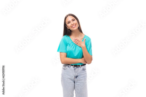 Fototapeta 30 year old attractive brunette woman with flowing straight hair put on a blue T-shirt and jeans