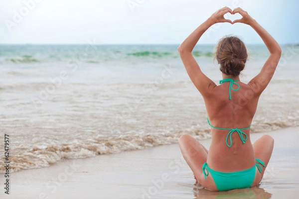 Fototapeta photo back view young woman in bikini posing on beach