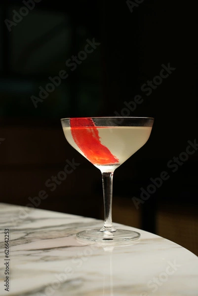 Fototapeta Red line cocktail glass on a marble bar counter