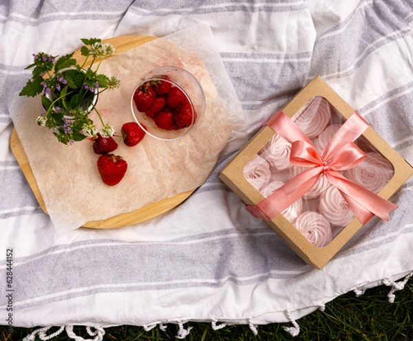 Fototapeta homemade marshmallow zephyr with strawberry taste on wooden boards. strawberries slice , sugar powder top view.food photography